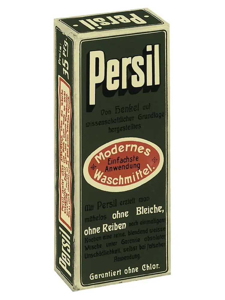 Scatola vintage del detersivo Persil con testo in tedesco ed etichetta ovale rossa che evidenzia la sua applicazione moderna e facile.