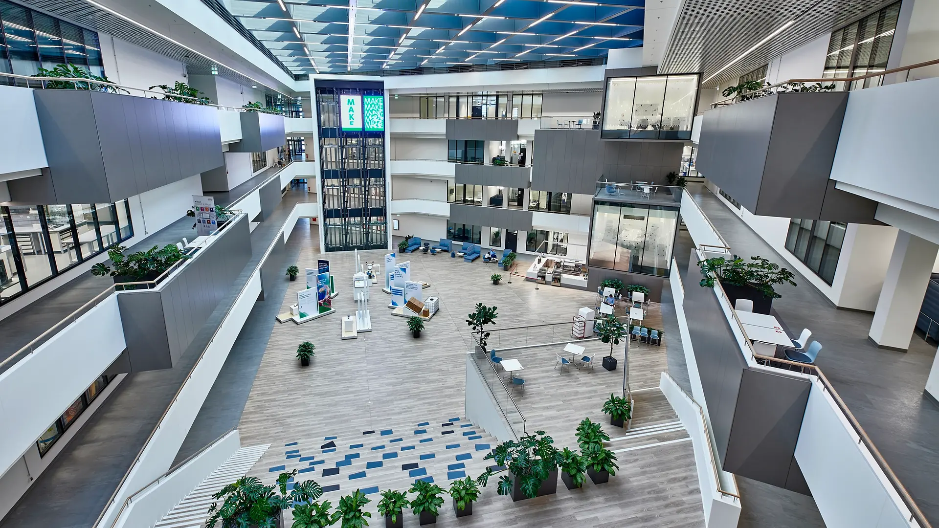 Vista interna dell'Inspiration Center di Düsseldorf con il grande cortile al centro. L'immagine mostra anche i laboratori high-tech con facciata in vetro, distribuiti su quattro piani.